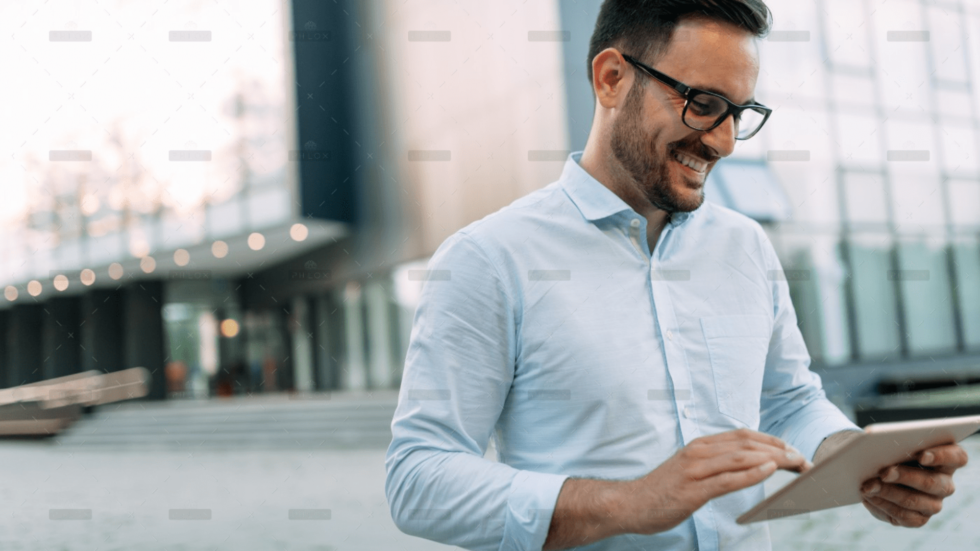 demo-attachment-1806-portrait-of-businessman-in-glasses-holding-tablet-AWVHCJU